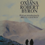 Book cover of 'The Road to Oxiana' by Robert Byron, featuring two figures walking in a mountainous landscape