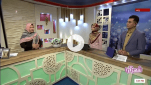 TV studio discussion featuring three presenters, two women and one man, in a colorful and decorative set, engaging in a live program