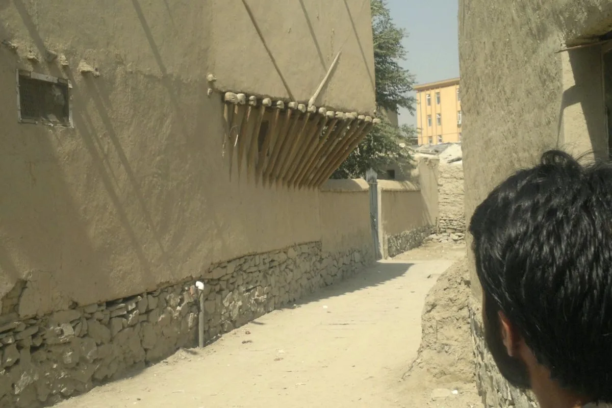 A cantilever structure in the Murad Khani district of Kabul, Afghanistan, showcasing traditional mudbrick architecture and timber support elements.